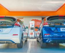 Carros elétricos sendo abastecidos em eletropostos